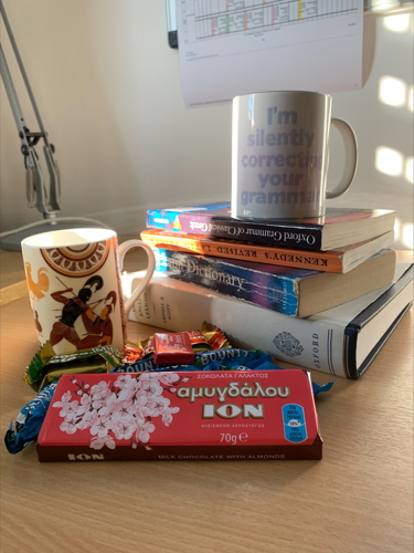 A selection of books, coffe cups and Greek chocolate