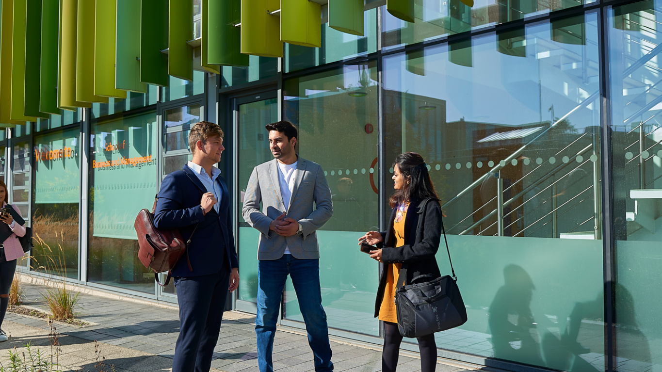 Students talking outside Business School building