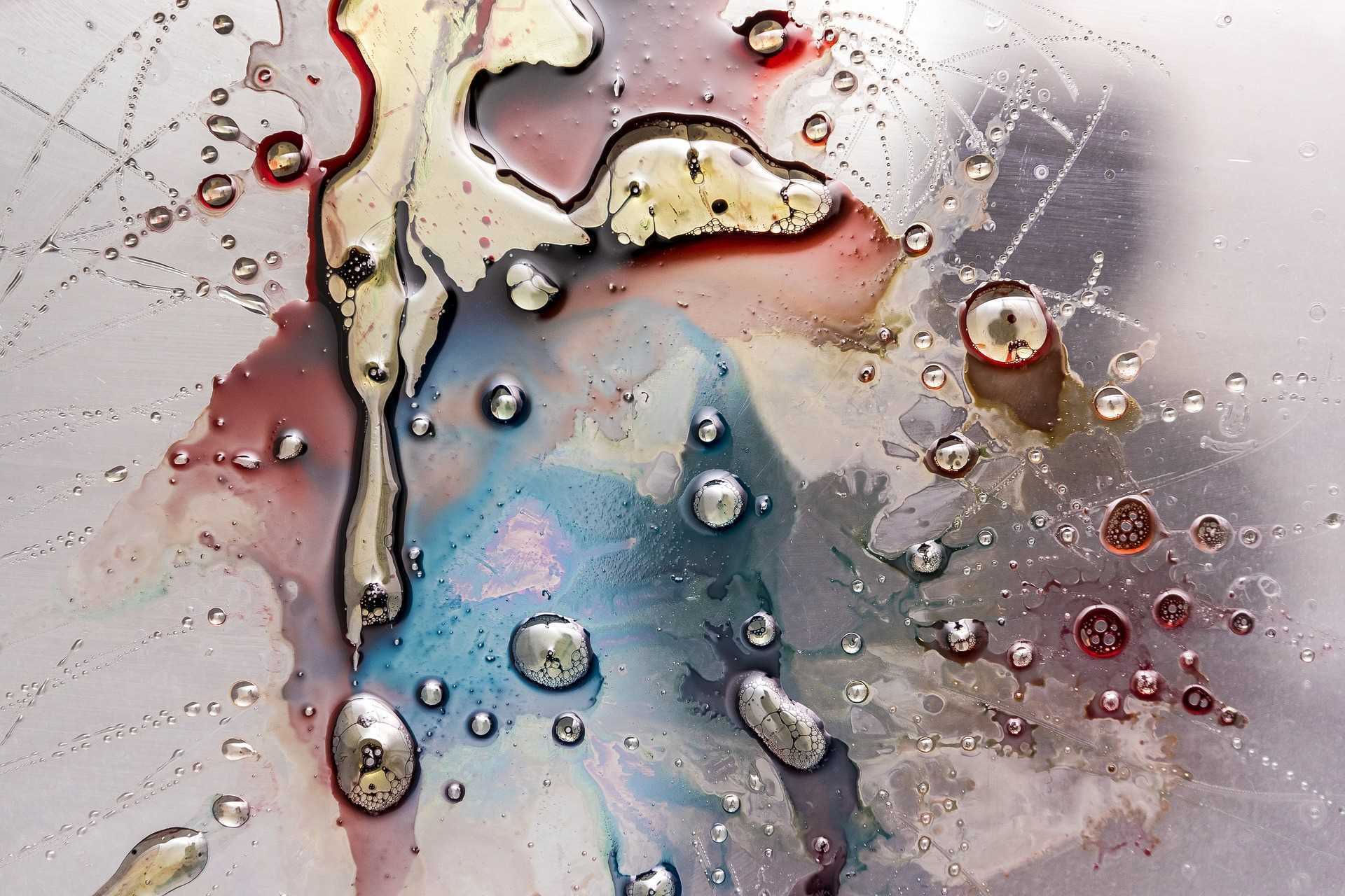 A piece of abstract art made of blobs of paint and water