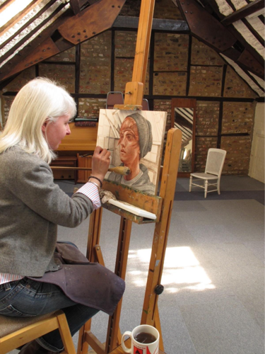 A person painting on an easel

AI-generated content may be incorrect.
