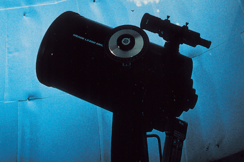 Large telescope against a blue background