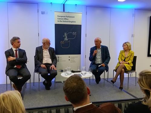 Four people seated at a stage. A banner reading "European Parliament Liaison Office in the UK" is between them