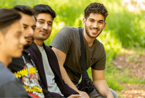 Four students on a sunlit bench
